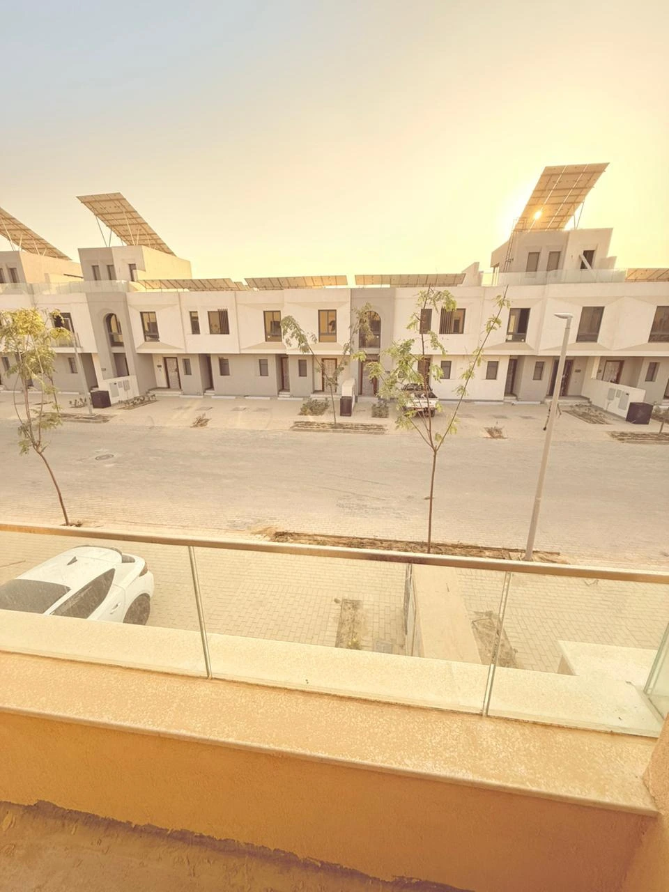 View from the upper-floor balcony over the SODIC VYE townhouse street, New Zayed